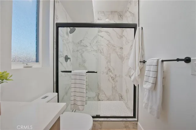 a bathroom with a shower and a toilet