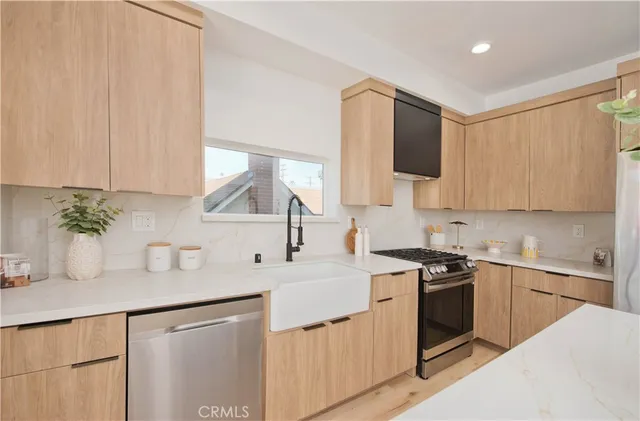 a kitchen with a sink stove and cabinets