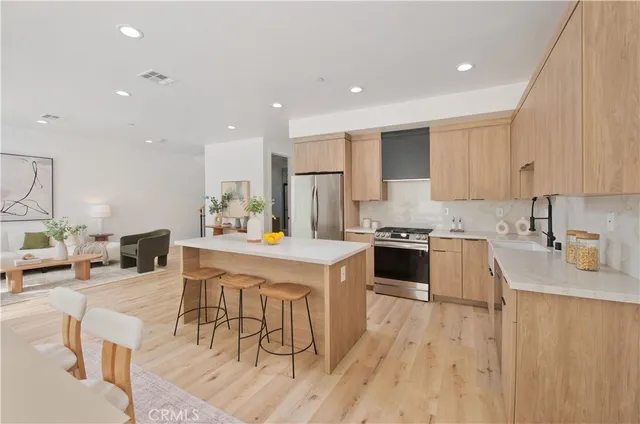 a kitchen with a sink a stove a refrigerator and cabinets