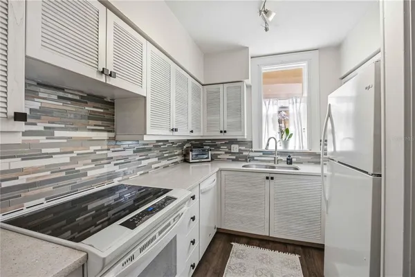 a kitchen with cabinets and appliances