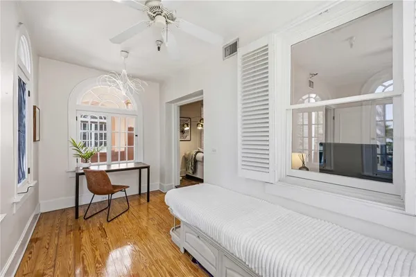 a spacious bedroom with a bed and a chandelier