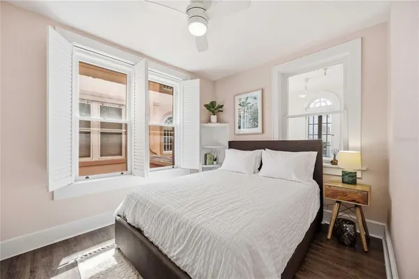 a bedroom with a large bed and a window
