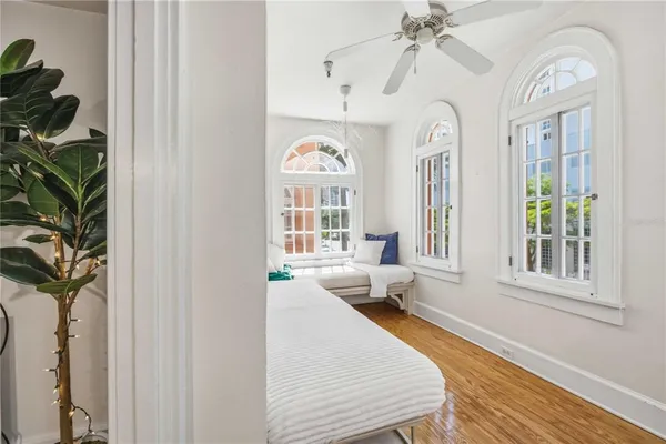 a spacious bedroom with a large bed and a chandelier
