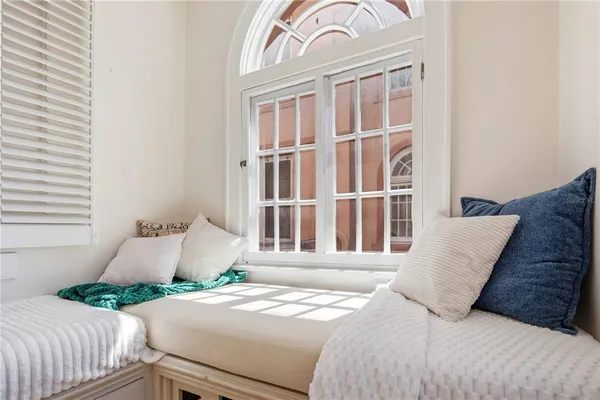 a bedroom with a bed and a window