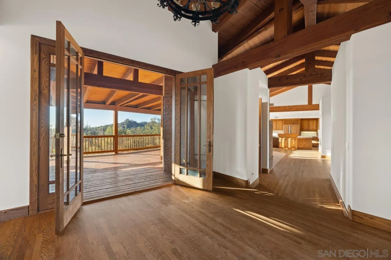 15718 Fruitvale Road Valley Center, CA 92082 - Photo 15 of 49 an empty room with wooden floor and windows