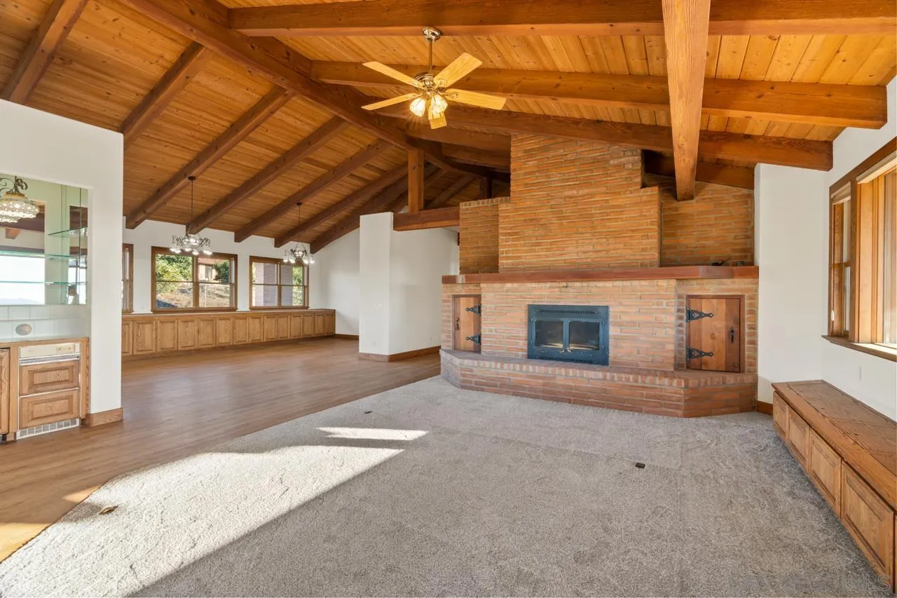 15718 Fruitvale Road Valley Center, CA 92082 - Photo 19 of 49 a view of a livingroom with wooden floor and a fireplace