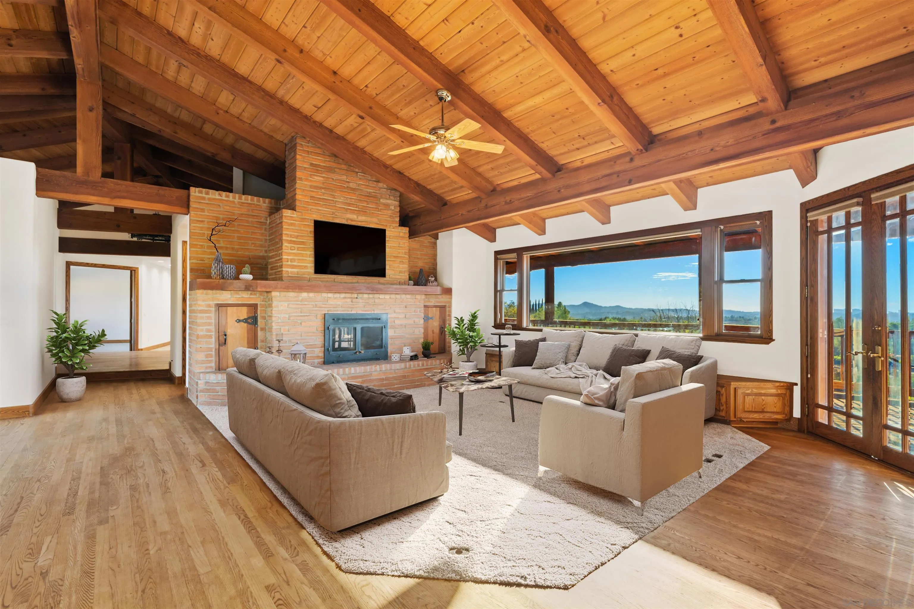 15718 Fruitvale Road Valley Center, CA 92082 - Photo 20 of 49 a living room with furniture a fireplace and a flat screen tv