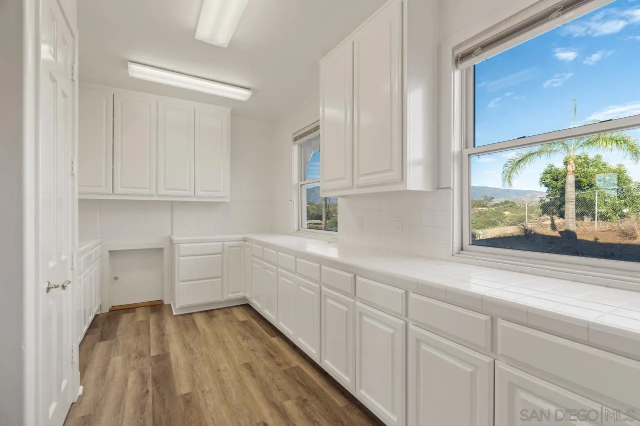 15718 Fruitvale Road Valley Center, CA 92082 - Photo 31 of 49 a kitchen with sink and cabinets
