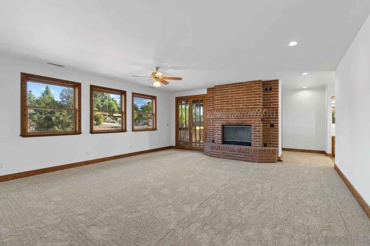 15718 Fruitvale Road Valley Center, CA 92082 - Photo 36 of 49 an empty room with windows and fireplace