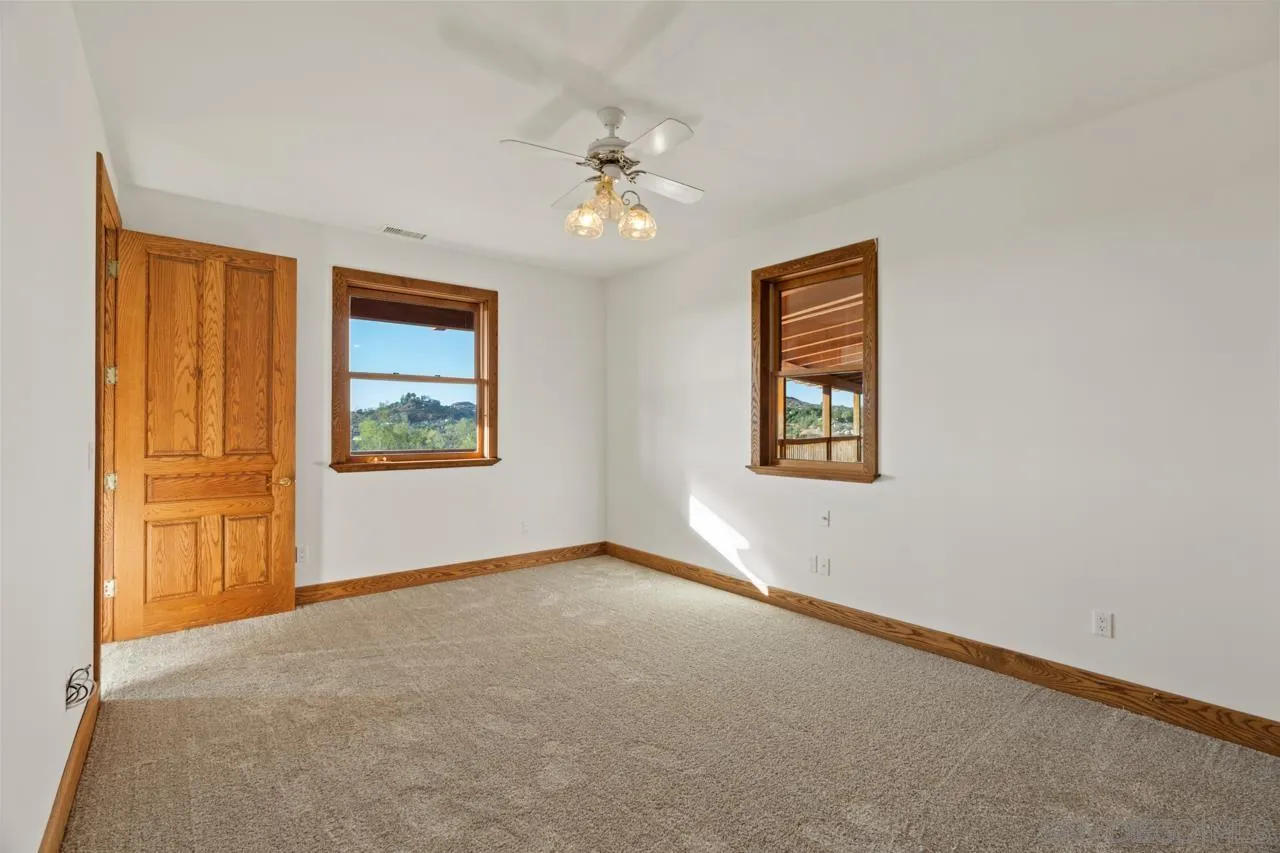 15718 Fruitvale Road Valley Center, CA 92082 - Photo 40 of 49 an empty room with windows and closet