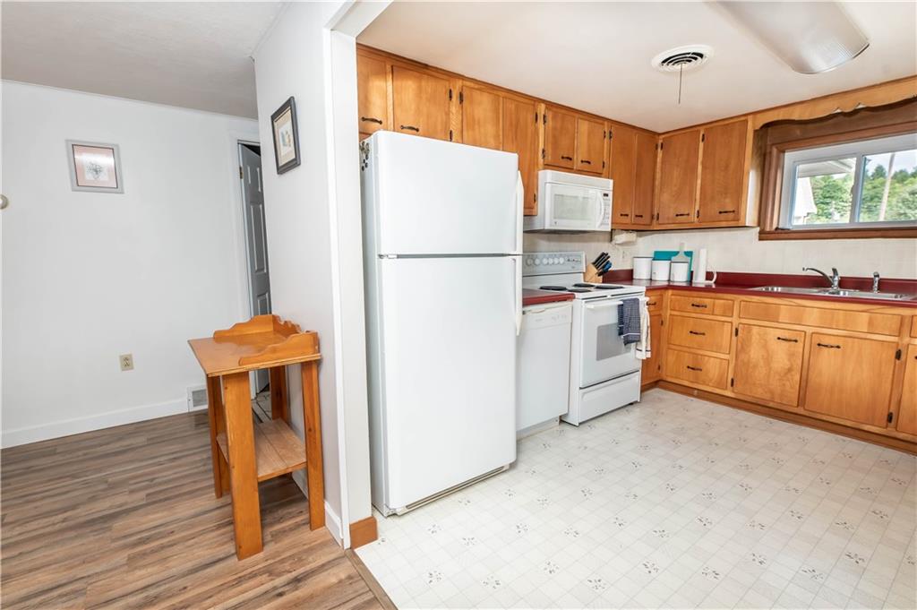 64 North Ridge Road Shelocta, PA 15774 - Photo 12 of 25 a kitchen with stainless steel appliances granite countertop a refrigerator sink and wooden cabinets