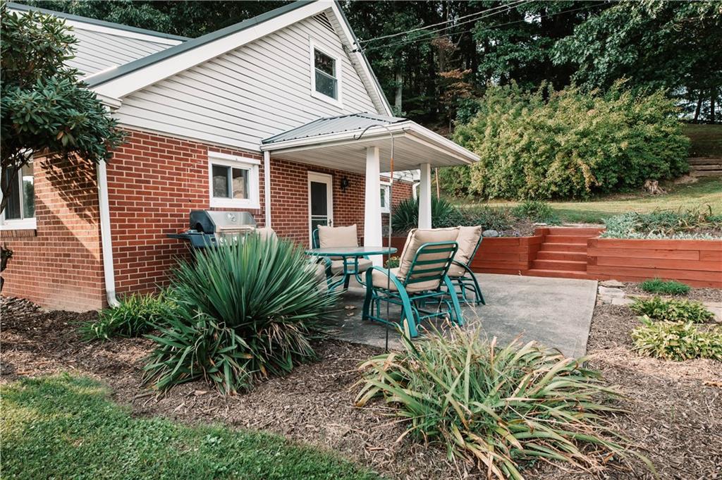 64 North Ridge Road Shelocta, PA 15774 - Photo 6 of 25 a view of patio with a table and chairs under an umbrella