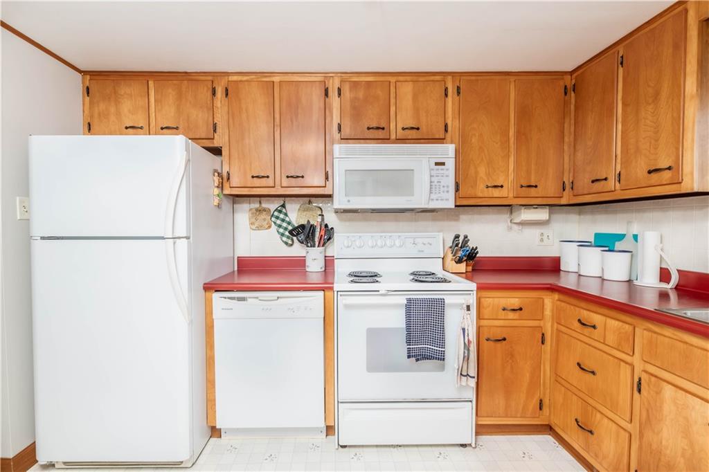 64 North Ridge Road Shelocta, PA 15774 - Photo 8 of 25 a kitchen with a refrigerator a stove a sink and cabinets