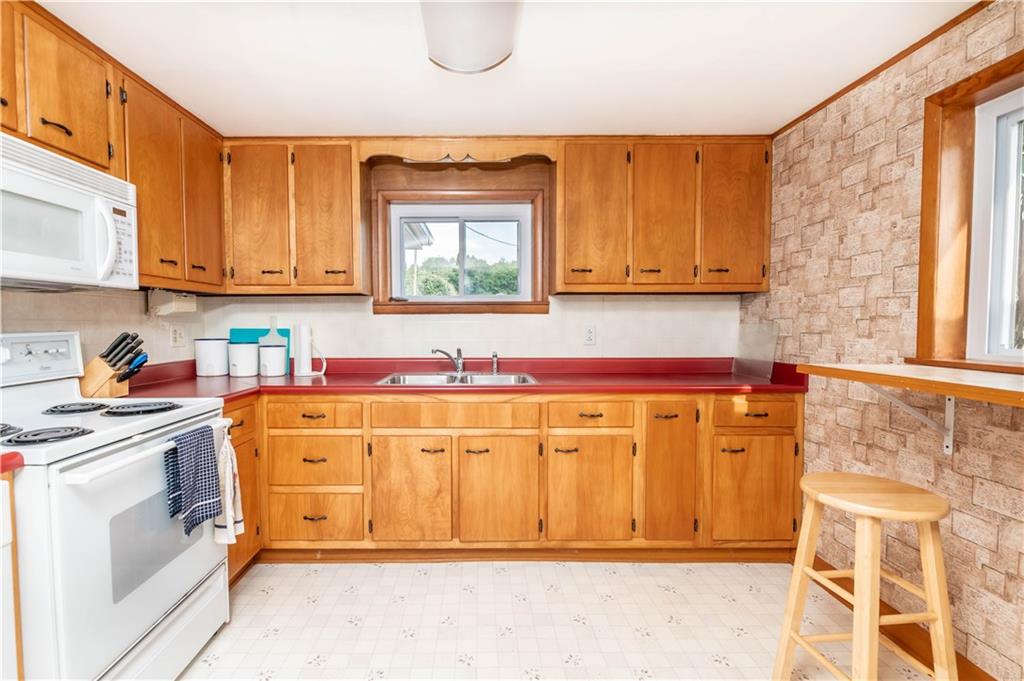 64 North Ridge Road Shelocta, PA 15774 - Photo 10 of 25 a utility room with stainless steel appliances wooden cabinets a stove and a window