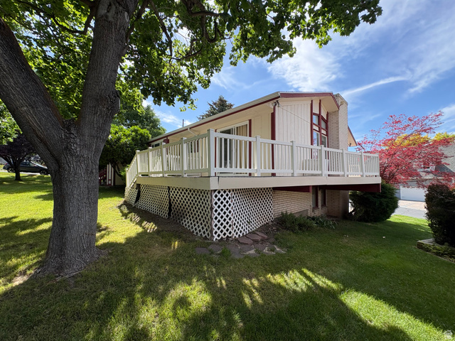 595 Meadowlark Road Orem, UT 84097 - Photo 81 of 87 Expansive elevated deck with white railing, overlooking a verdant lawn