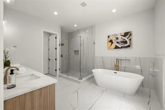 a spacious bathroom with a sink and mirror
