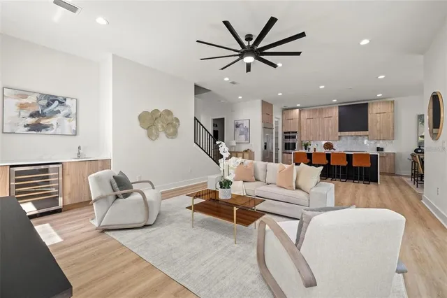 a living room with furniture and a view of kitchen