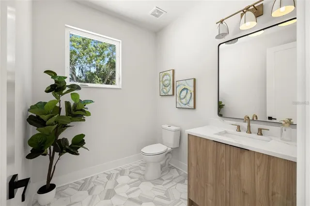 a bathroom with a toilet a sink and a mirror