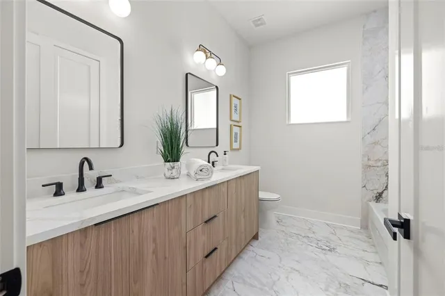 a bathroom with a double vanity sink and a mirror