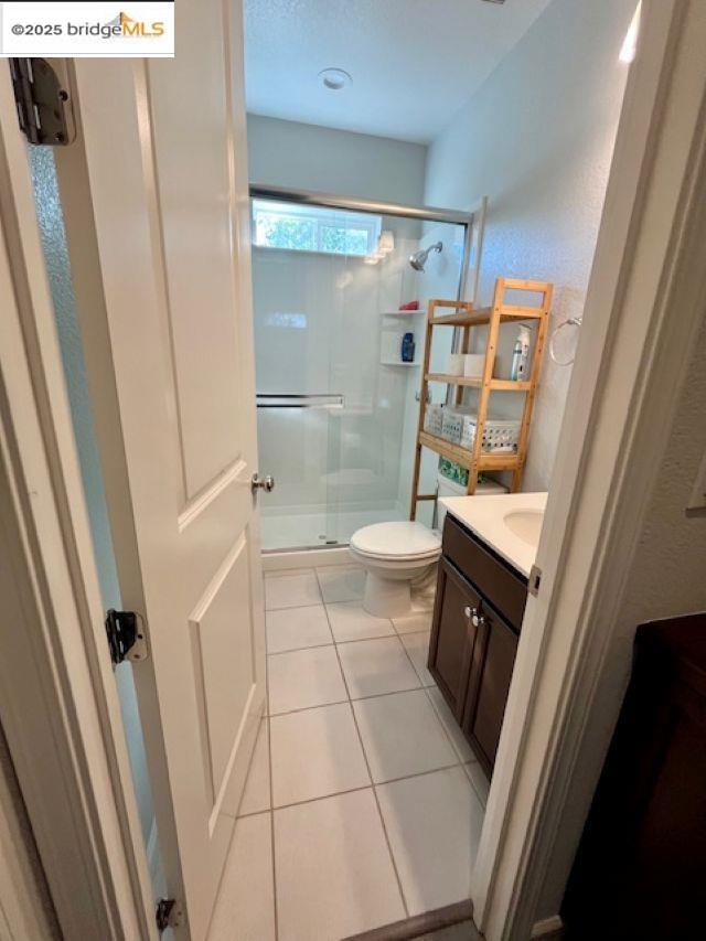 761 Stickney Way Oakley, CA 94561 - Photo 14 of 18 Full bath with vanity, light tile patterned floors, a stall shower, and a textured wall