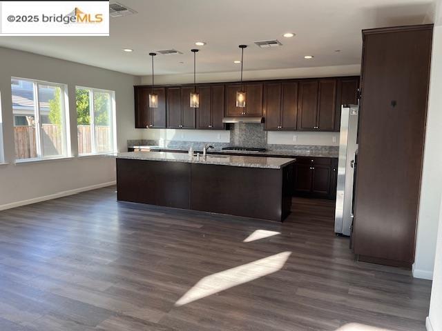 761 Stickney Way Oakley, CA 94561 - Photo 2 of 18 Kitchen featuring dark brown cabinetry, decorative light fixtures, recessed lighting, a kitchen island with sink, and dark wood-style floors