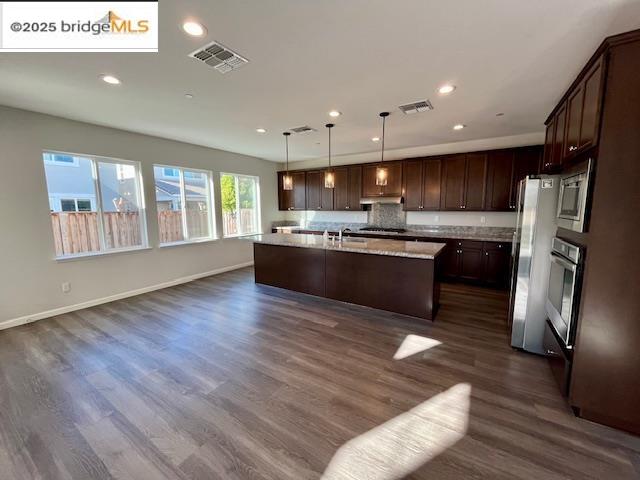 761 Stickney Way Oakley, CA 94561 - Photo 18 of 18 Kitchen featuring pendant lighting, open floor plan, recessed lighting, dark wood-style floors, and dark brown cabinets