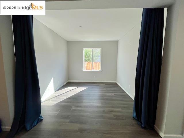 761 Stickney Way Oakley, CA 94561 - Photo 5 of 18 Empty room with dark wood-type flooring and baseboards