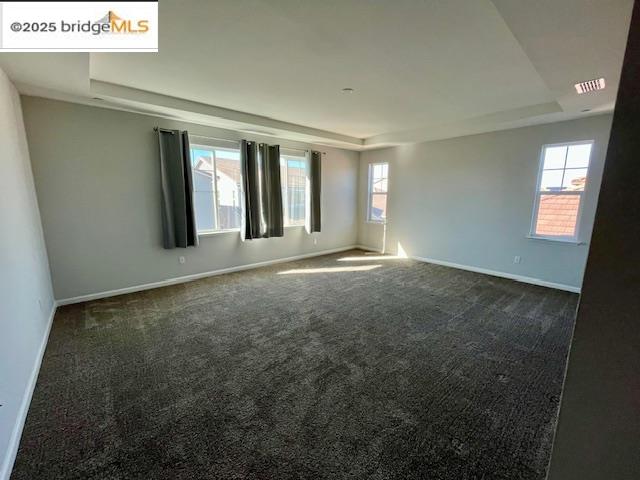 761 Stickney Way Oakley, CA 94561 - Photo 6 of 18 Unfurnished room with a tray ceiling, dark carpet, and healthy amount of natural light