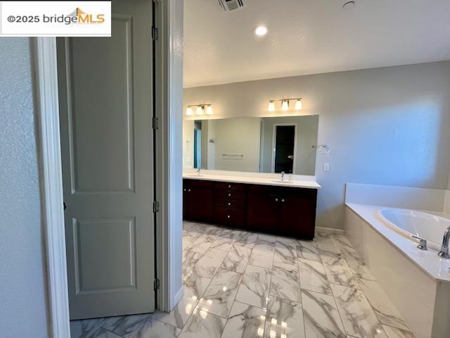761 Stickney Way Oakley, CA 94561 - Photo 8 of 18 Bathroom with a garden tub, double vanity, and light marble finish floors