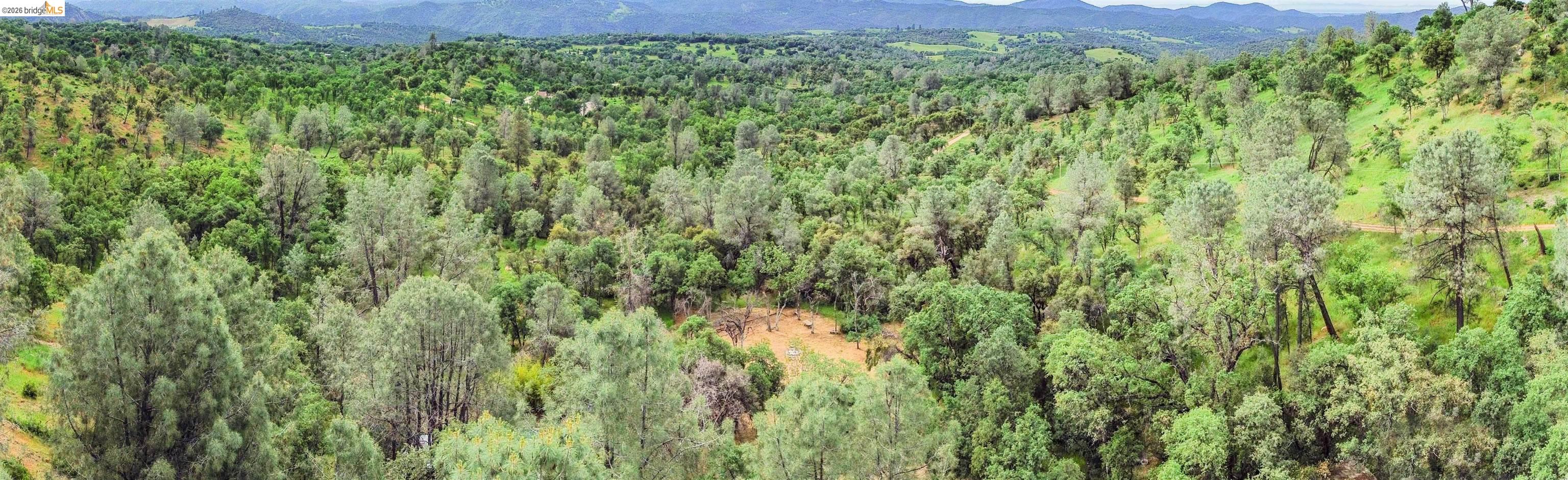 17270 Robin Ridge Road Sonora, CA 95370 - Photo 59 of 60 Aerial view of a mountain backdrop and a heavily wooded area