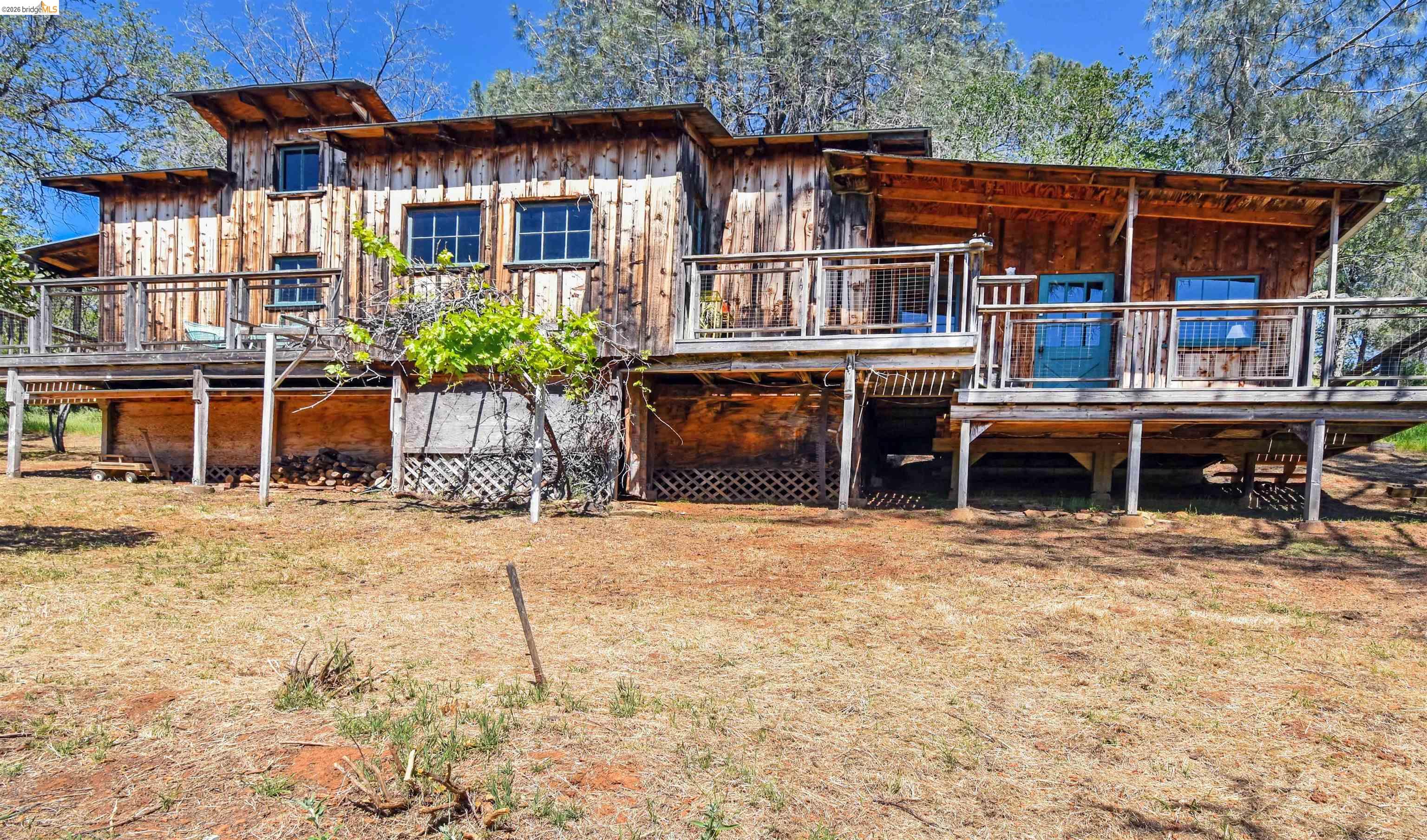17270 Robin Ridge Road Sonora, CA 95370 - Photo 10 of 60 Rear view of house featuring a wooden deck and board and batten siding