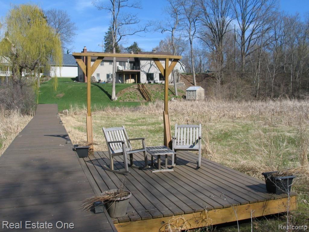 820 Brighton Lake Road Brighton, MI 48116 - Photo 5 of 42 Private Dock with house in back ground (under gable) Pier is shared with neighbors to left