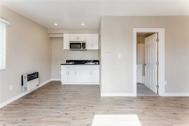 a view of a kitchen with microwave and cabinets
