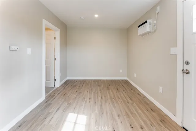 a view of a room with wooden floor and window