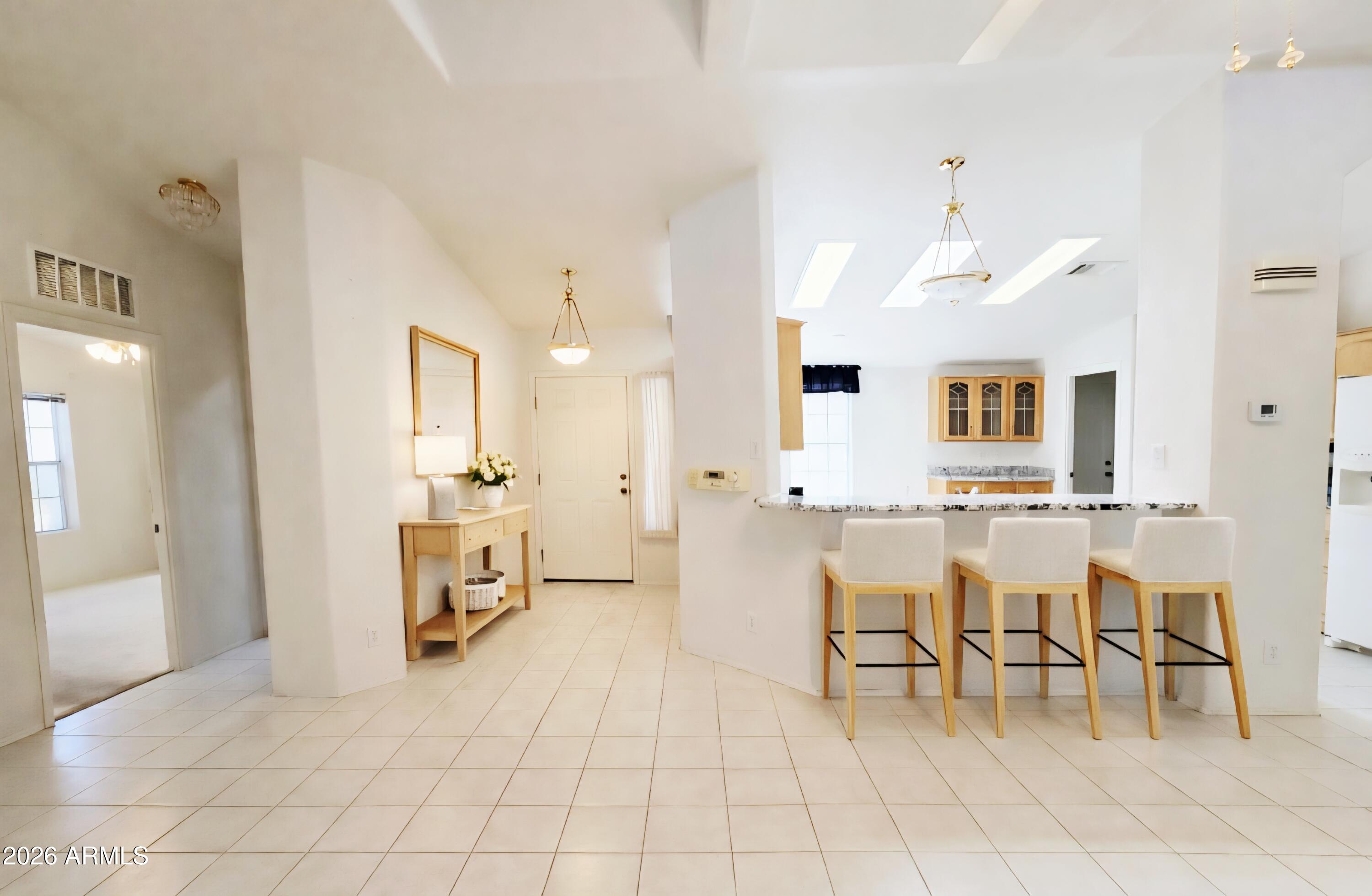 3301 South Goldfield Road, Unit 3004 Apache Junction, AZ 85119 - Photo 7 of 67 a view of kitchen with dining area and chandelier