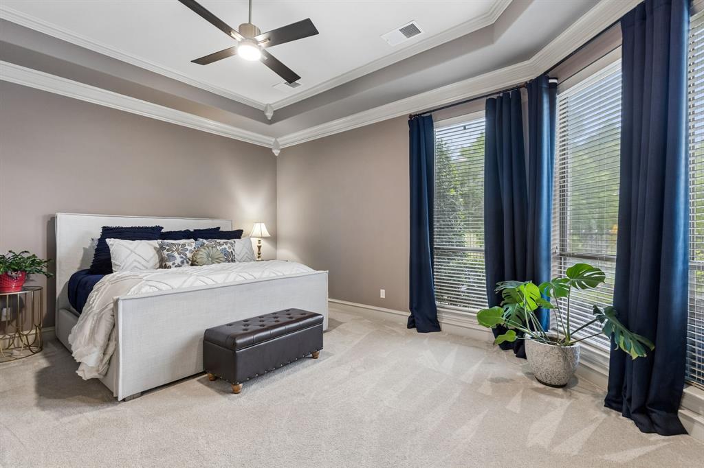 8517 Navigation Drive Rowlett, TX 75088 - Photo 19 of 39 a bedroom with bed and a potted plant