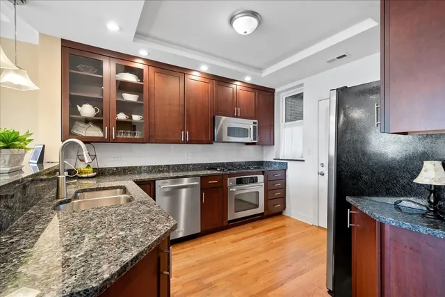 a kitchen with stainless steel appliances a sink stove and microwave