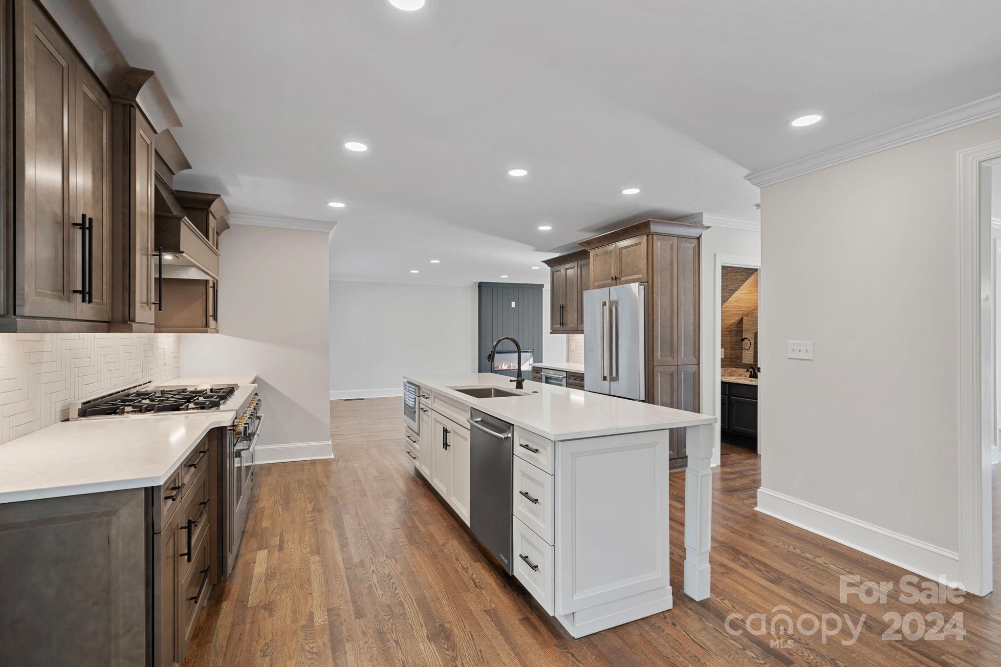 21140 Bethel Church Road Cornelius, NC 28031 - Photo 11 of 48 a kitchen with stainless steel appliances granite countertop a sink stove and refrigerator