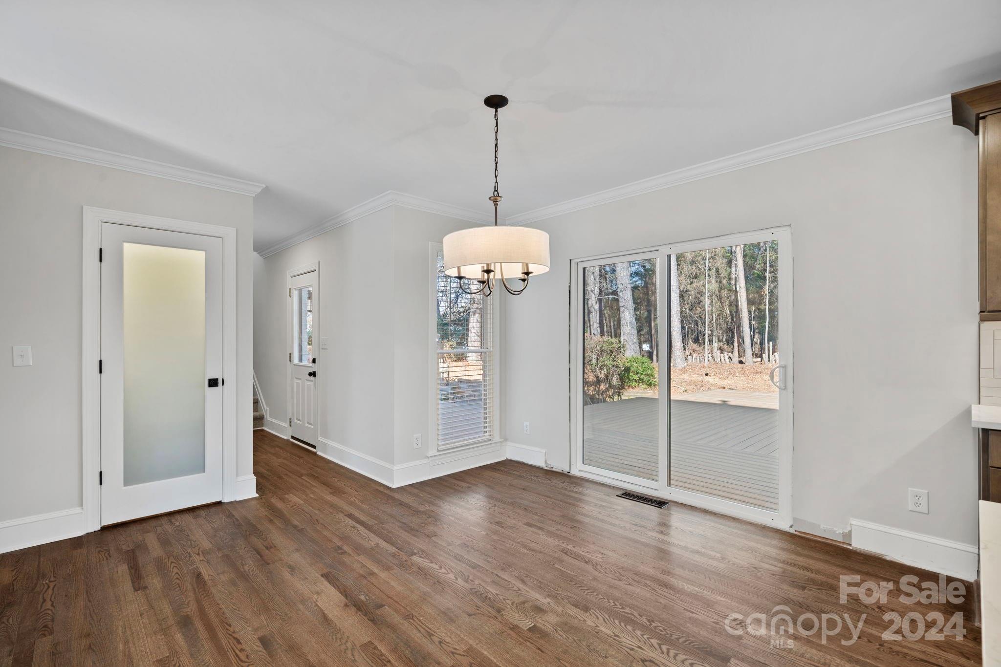 21140 Bethel Church Road Cornelius, NC 28031 - Photo 13 of 48 a view of an empty room with wooden floor and windows