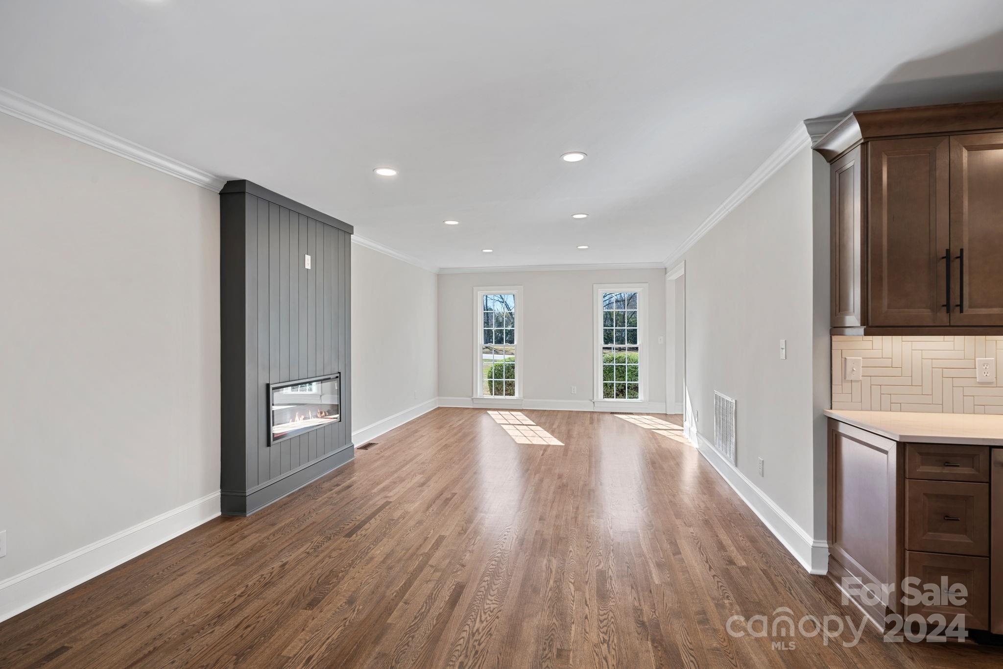 21140 Bethel Church Road Cornelius, NC 28031 - Photo 15 of 48 a view of an empty room with wooden floor and a window