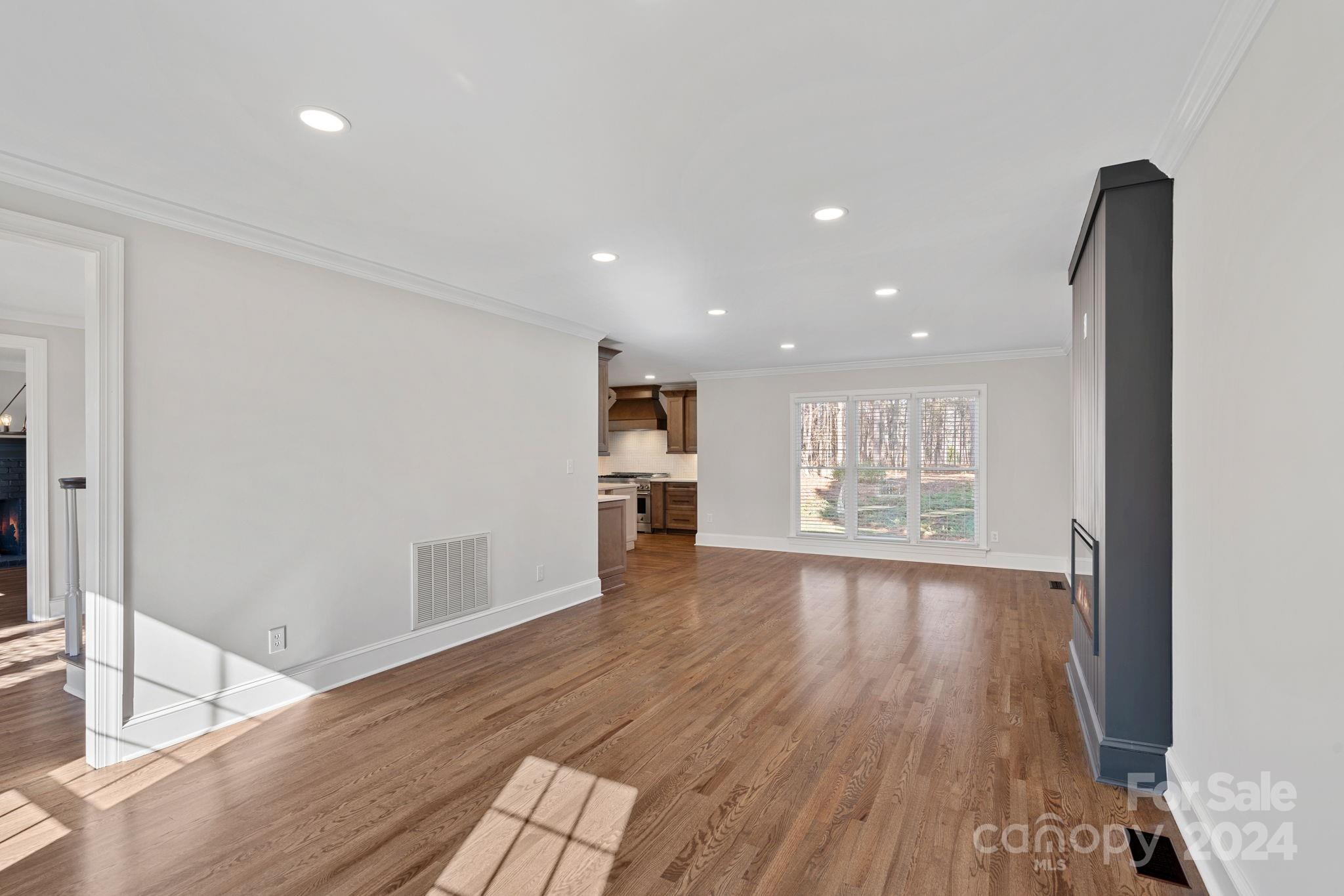 21140 Bethel Church Road Cornelius, NC 28031 - Photo 16 of 48 a view of an empty room with wooden floor and a window