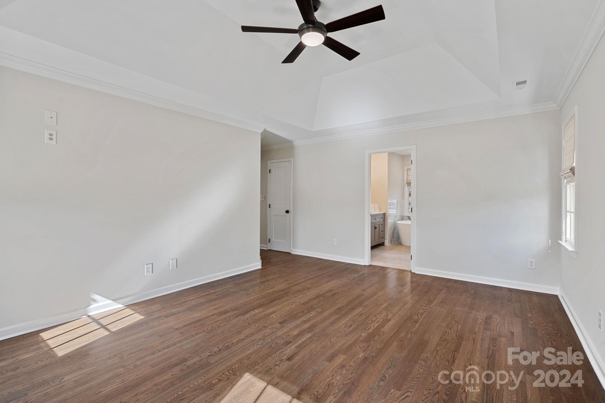 21140 Bethel Church Road Cornelius, NC 28031 - Photo 19 of 48 a view of empty room with wooden floor and ceiling fan