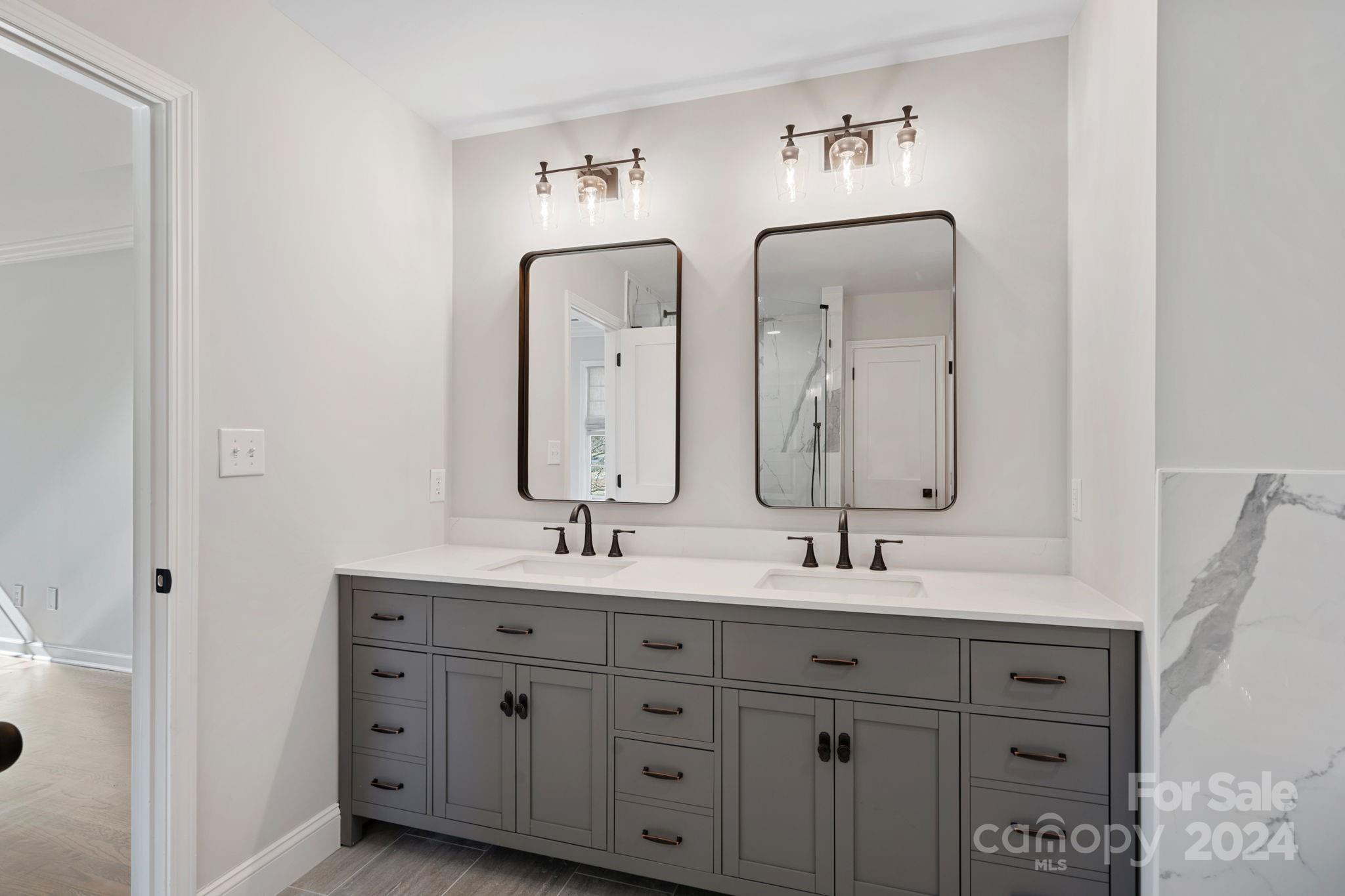 21140 Bethel Church Road Cornelius, NC 28031 - Photo 20 of 48 a bathroom with a double vanity sink and a mirror