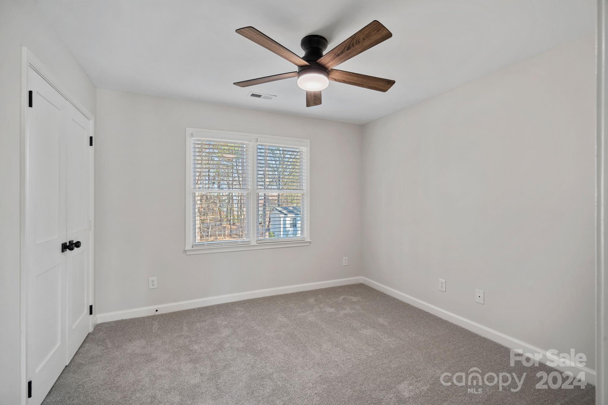21140 Bethel Church Road Cornelius, NC 28031 - Photo 24 of 48 an empty room with ceiling fan and windows