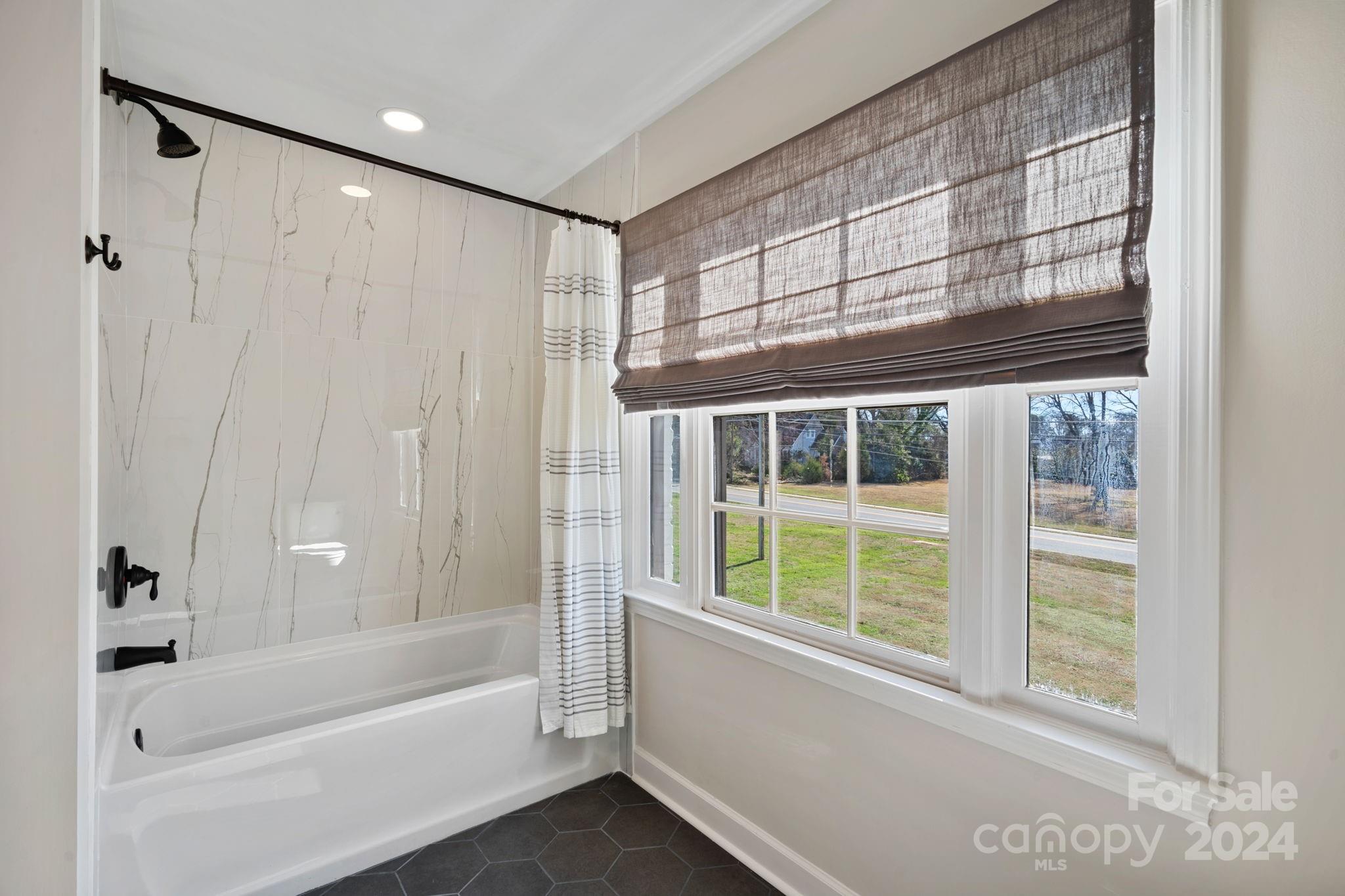 21140 Bethel Church Road Cornelius, NC 28031 - Photo 26 of 48 a bathroom with a bathtub and a shower