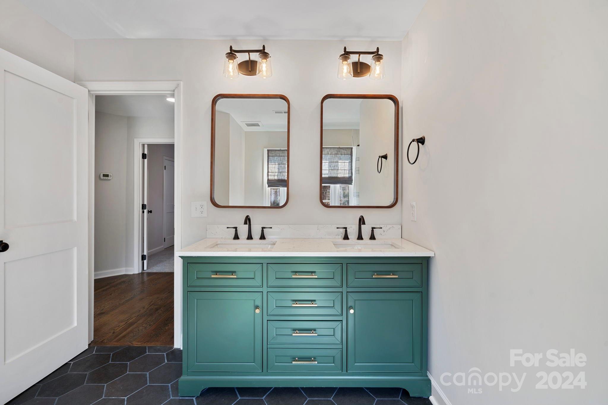 21140 Bethel Church Road Cornelius, NC 28031 - Photo 27 of 48 a bathroom with double vanity sinks and a mirror