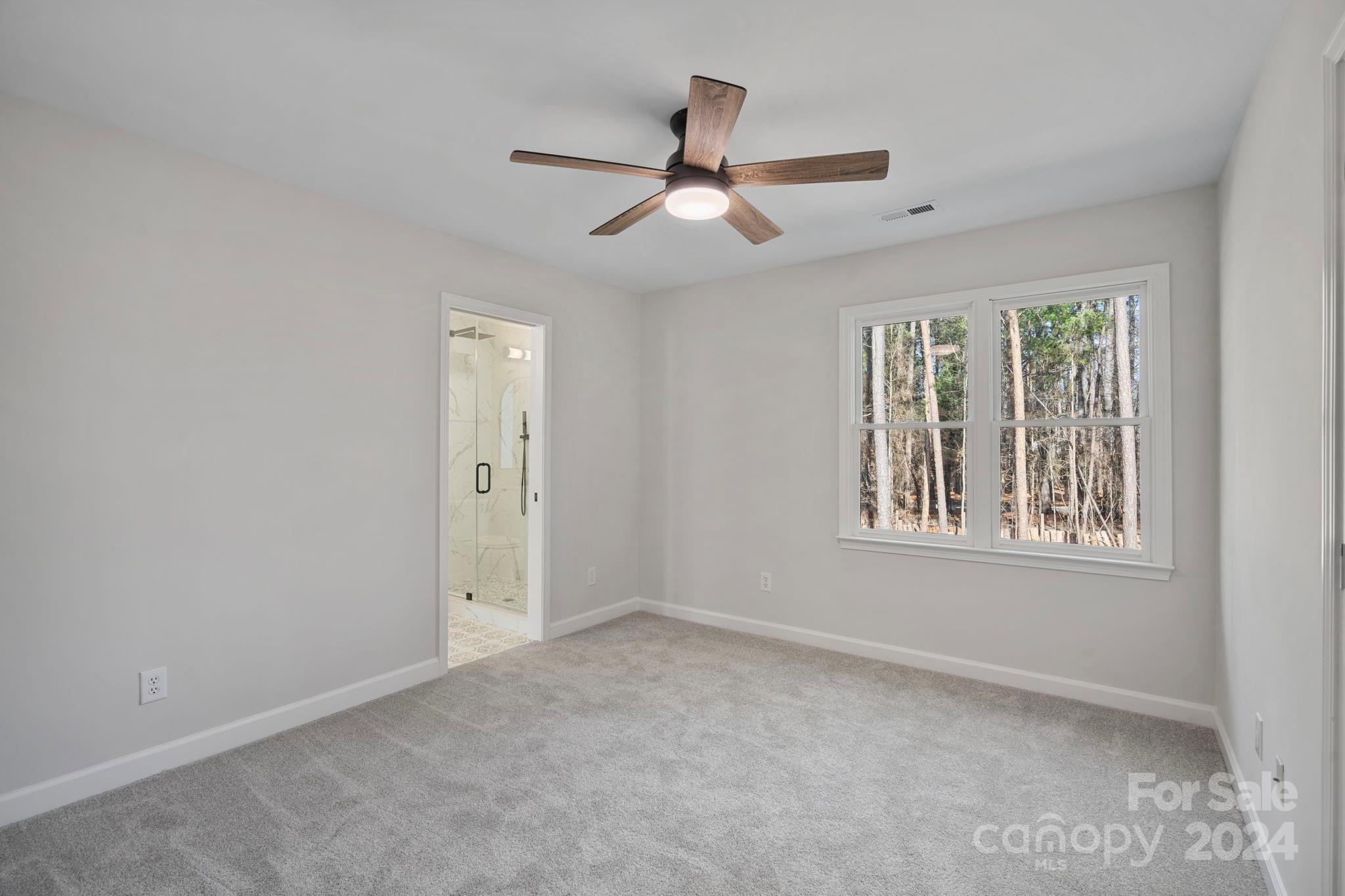 21140 Bethel Church Road Cornelius, NC 28031 - Photo 29 of 48 an empty room with windows and fan