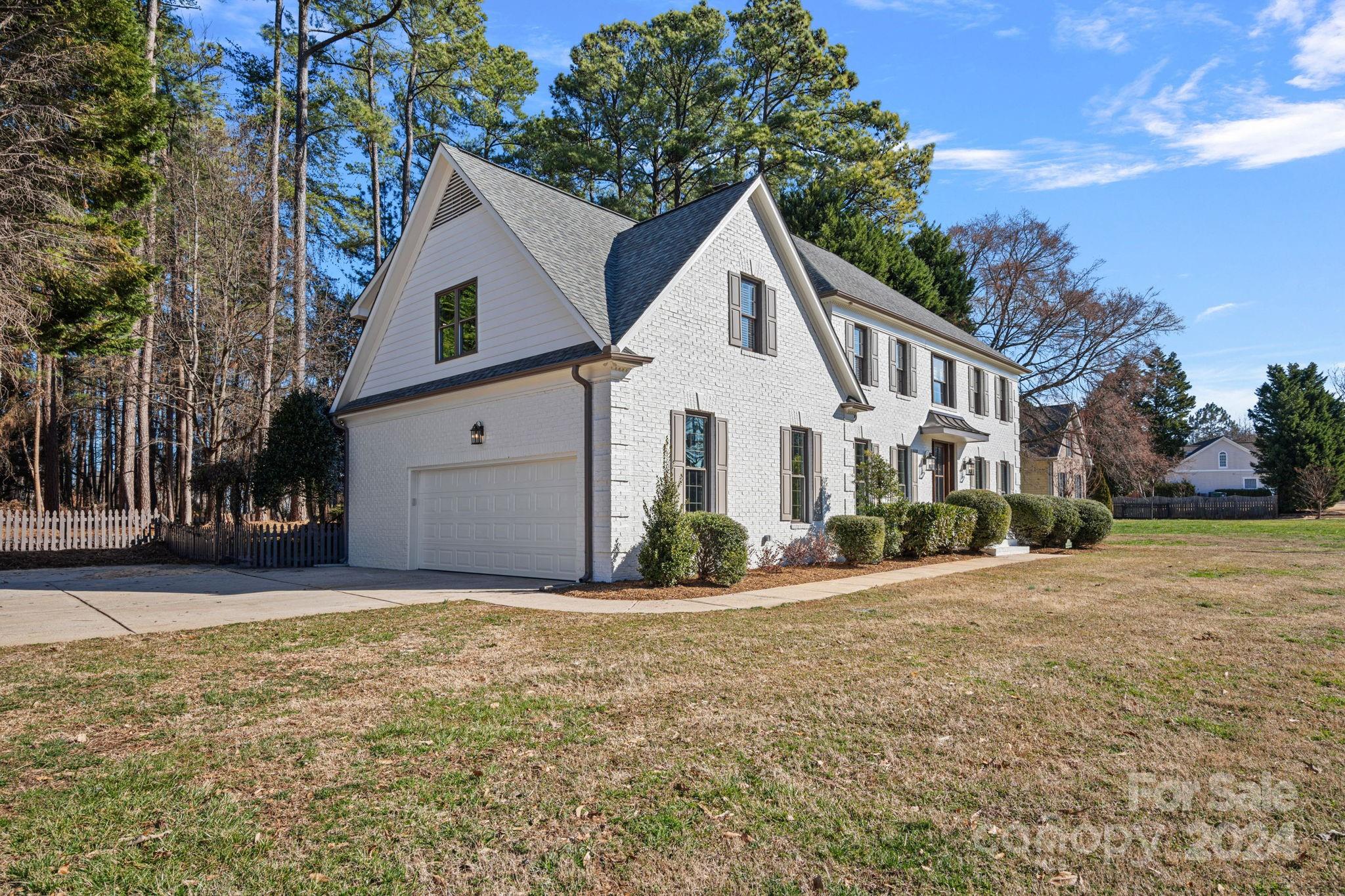 21140 Bethel Church Road Cornelius, NC 28031 - Photo 3 of 48 a front view of a house with a yard and garage