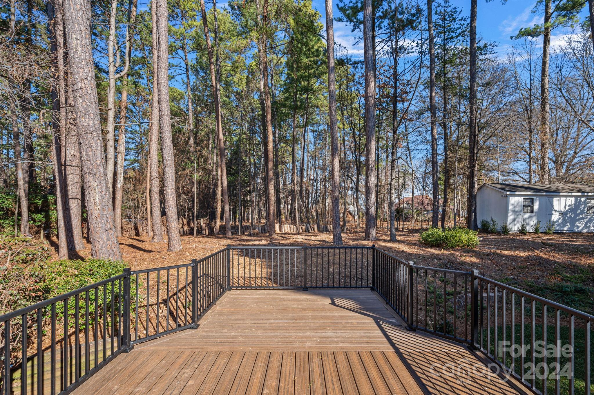 21140 Bethel Church Road Cornelius, NC 28031 - Photo 36 of 48 a view of a balcony with wooden floor and fence