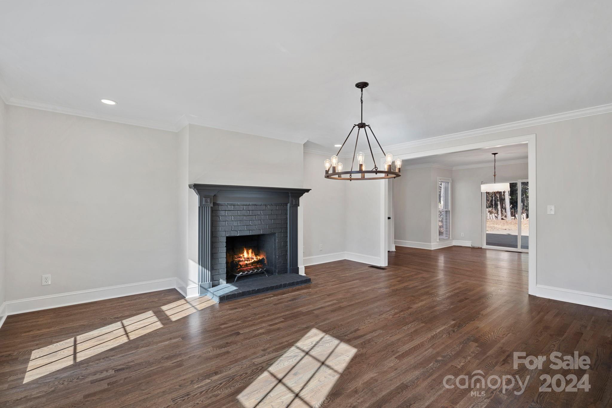 21140 Bethel Church Road Cornelius, NC 28031 - Photo 6 of 48 a view of empty room with wooden floor fireplace and a window